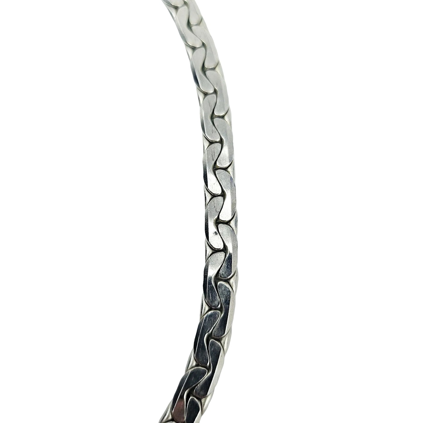 A close-up of a silver-toned metal chain bracelet with a wavy, interlocking link design, shown against a plain white background.